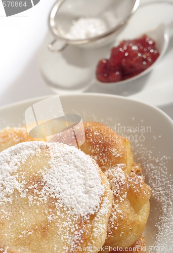 Image of Polish doughnuts poured with icing sugar