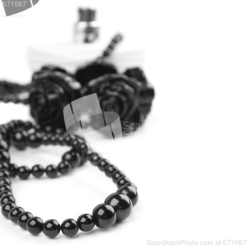 Image of black necklace, bracelet and parfume