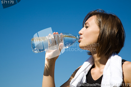 Image of Girl drinking water while exercise