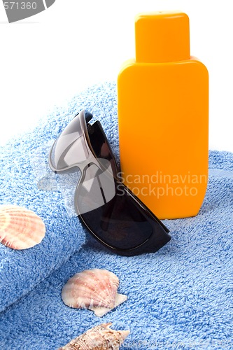 Image of towel, sunglasses and lotion