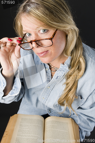 Image of pretty attractive blond woman close up reading glasses book