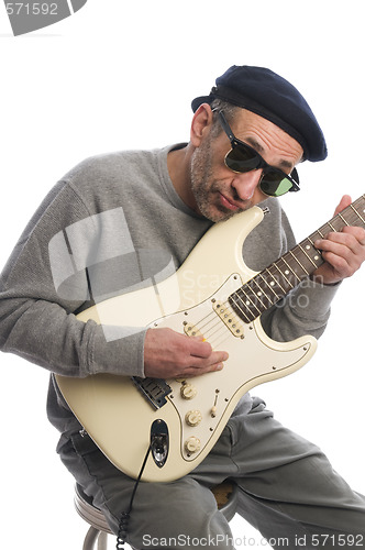 Image of senior man playing guitar