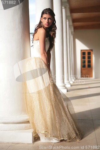 Image of girl in white-golden gown of the bride