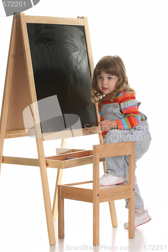 Image of little girl climbing on a chair