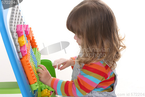 Image of girl playing colorful building toy blocks 