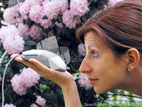 Image of Young girl holding computer mouse