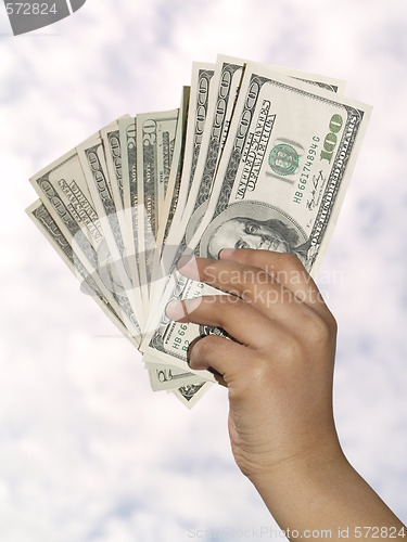 Image of hand with dollars