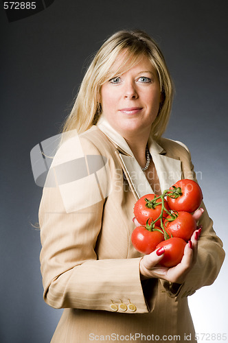 Image of attractive blond woman with bunch tomatoes fresh  for healthy li