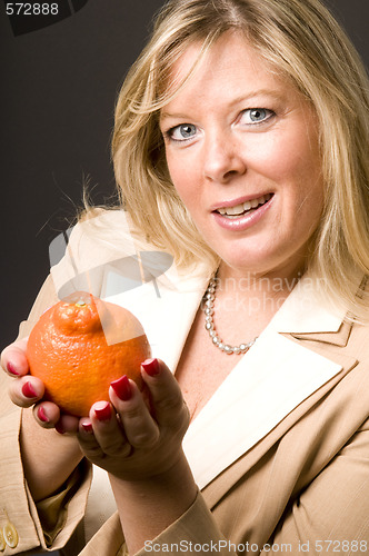 Image of attractive blond woman with mineola orage tangerine  fruit for h