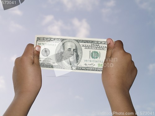 Image of holding 100 dollar