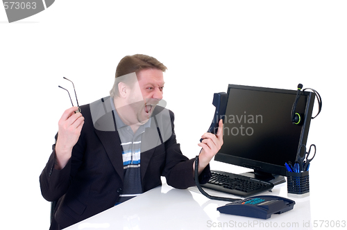 Image of Angry businessman on desk 