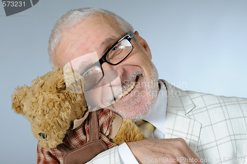 Image of Happy senior businessman with teddy bear