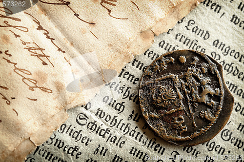 Image of Old coin and manuscripts