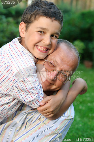 Image of Grandfather and kid outdoors