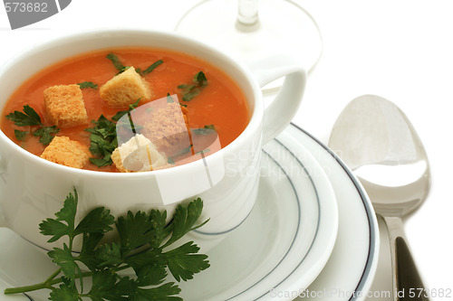 Image of Tomato soup with croutons in ceramic bowl on white