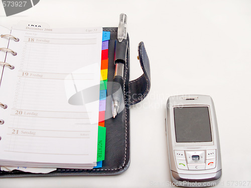 Image of Office objects - Pen diary and a cell phone