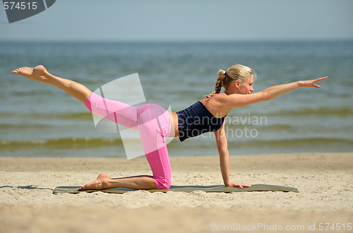 Image of Beautiful female workout on the beach