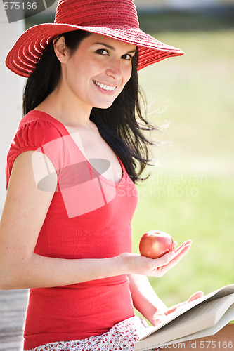 Image of Beautiful hispanic woman reading a book