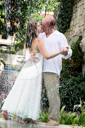 Image of Bride and groom kissing.