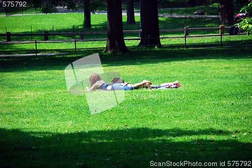 Image of Friends relaxing on green grass