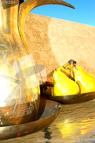 Image of Brass Decanter And Fruits On A Table