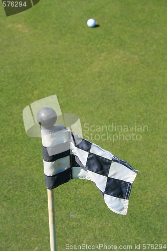 Image of Golf Course Flag And A Golf Ball