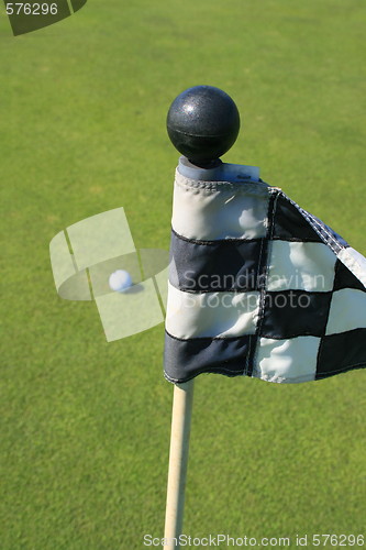 Image of Golf Course Flag And A Golf Ball