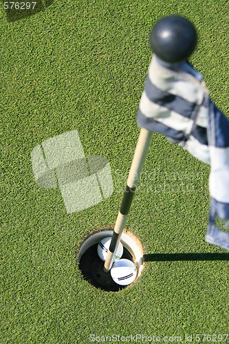 Image of Golf Course Flag And Two Golf Balls