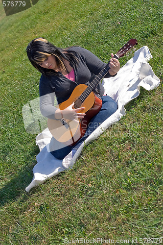 Image of Woman Playing Her Guitar