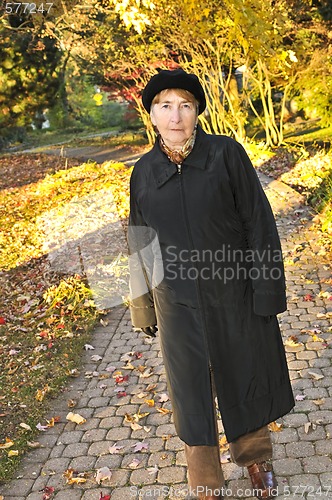 Image of Senior woman in fall park