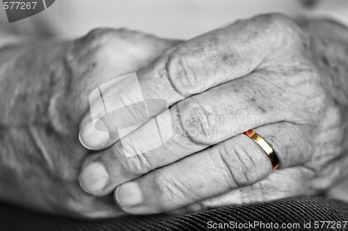 Image of Old hands with wedding band