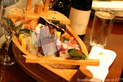 Image of Sushi boat with an assortment of culinary treats.