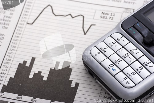 Image of Mobile Phone Over Charts
