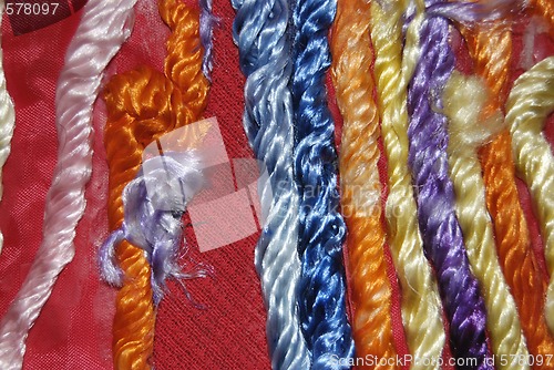 Image of Red Canvas Decorated With Colored Fibres