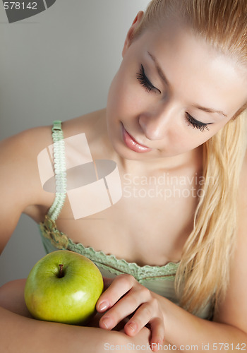Image of Blonde with apple
