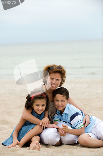 Image of Mother and kids on the beach