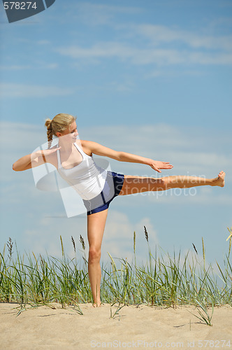 Image of Beautiful female workout on the beach
