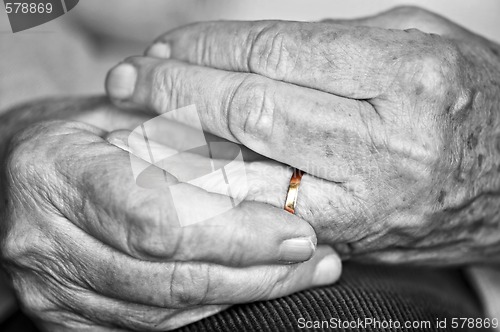 Image of Old hands with wedding band