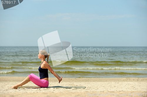 Image of Beautiful female workout on the beach