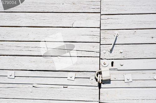 Image of White wooden gates with lock