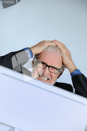 Image of Stressed senior businessman