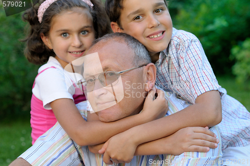Image of Grandfather and kids outdoors