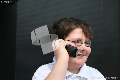 Image of Cute young boy talking on the telephone