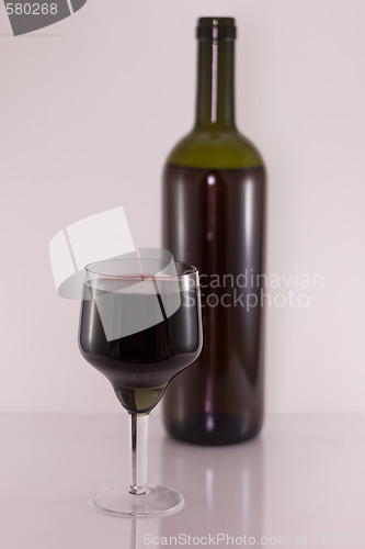 Image of Glass and bottle with red wine