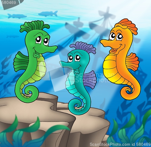 Image of Sea horses family with shipwreck