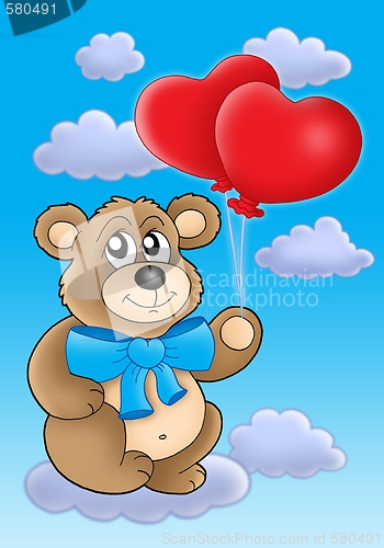 Image of Teddy bear with heart balloons on blue sky