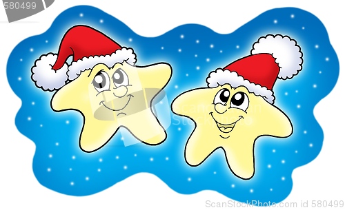 Image of Stars in Christmas caps on blue sky