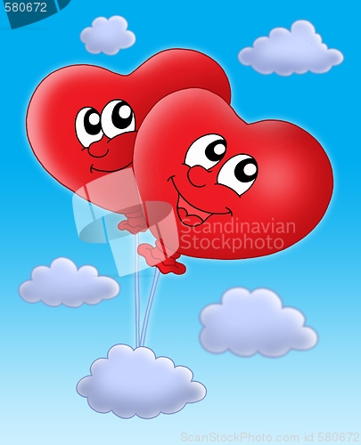 Image of Smilling hearts balloons on blue sky