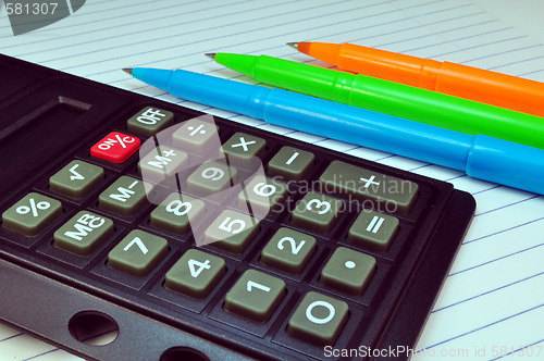 Image of Calculator, pens and notebook