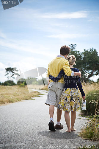 Image of Young caucasian couple walking in a park